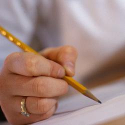 Person using a pencil to write