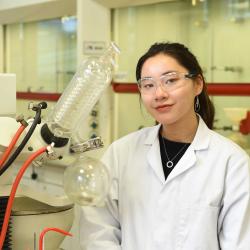 A female student in a lab alongside her equipment