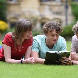 Students lying on the grass and studying