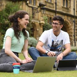 Students sitting and talking on grass