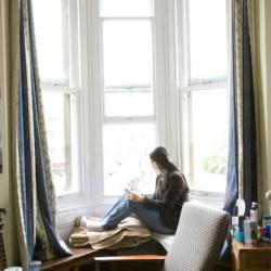 A student sitting in front of a window