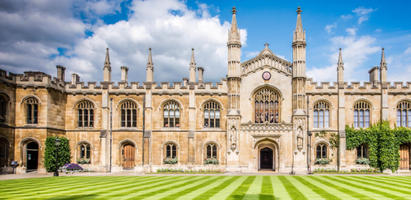 New Court - Corpus Christi College - University of Cambridge Corpus Christi College buildings with blue sky and green lawn stripes
