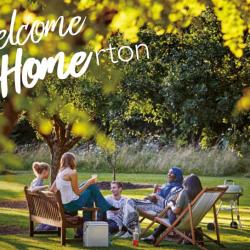 Welcome to Homerton text with students relaxing in Homerton gardens